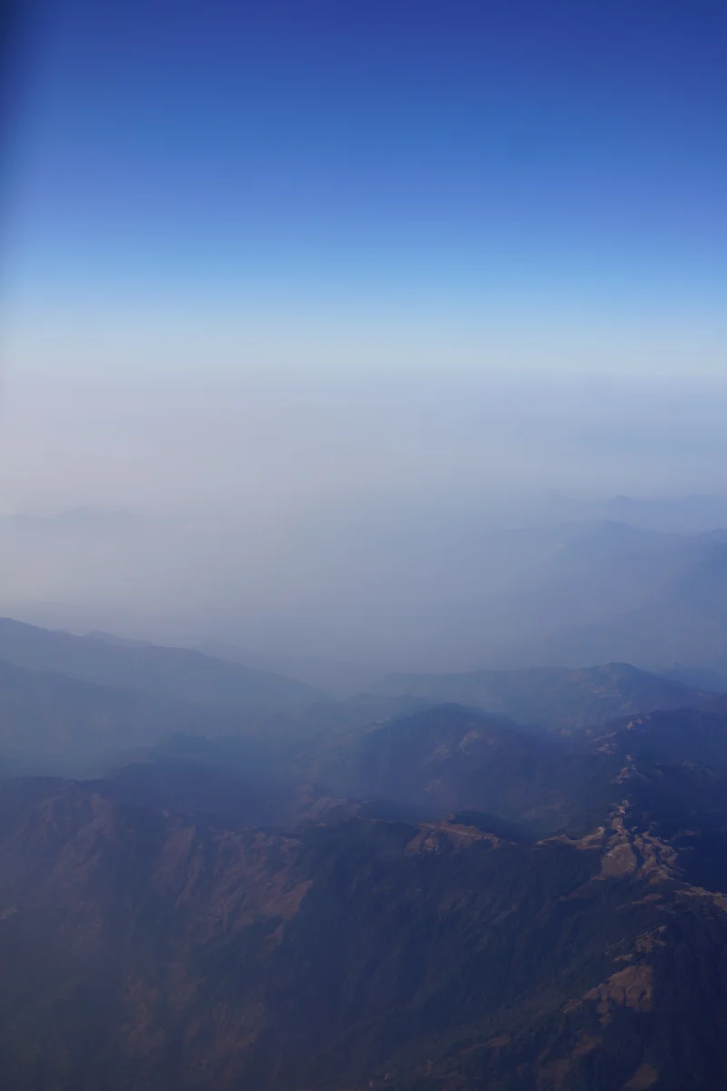 Misty Mountain Range Under Blue Sky