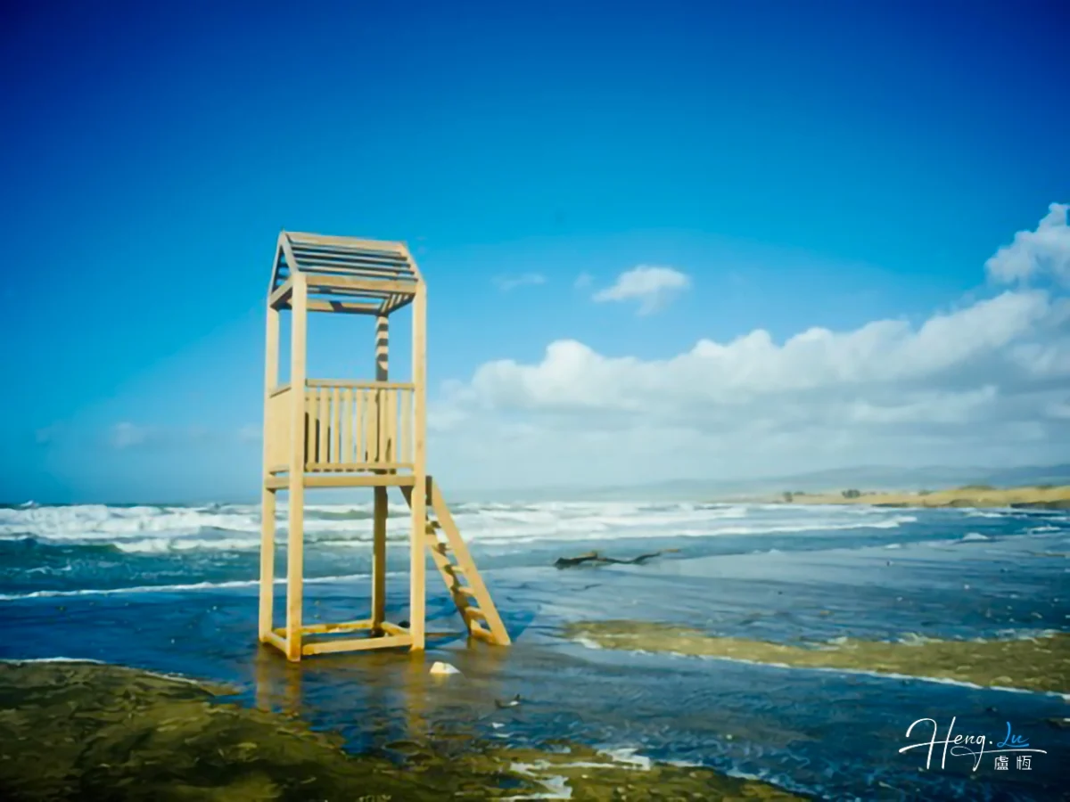 Wooden Lifeguard Tower On Seaside With Blue Sky