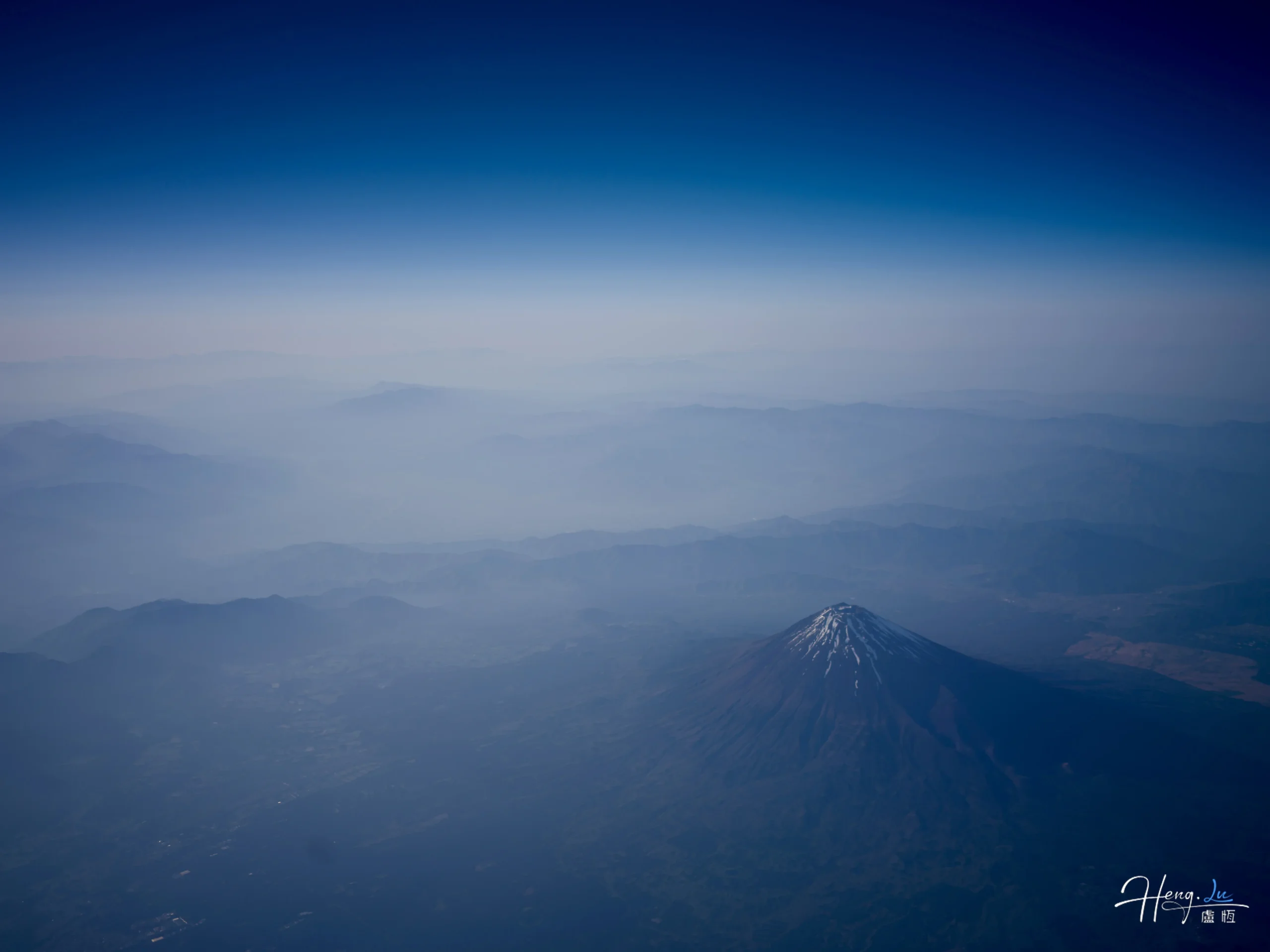 Aerial view of Mount Fuji with misty horizon