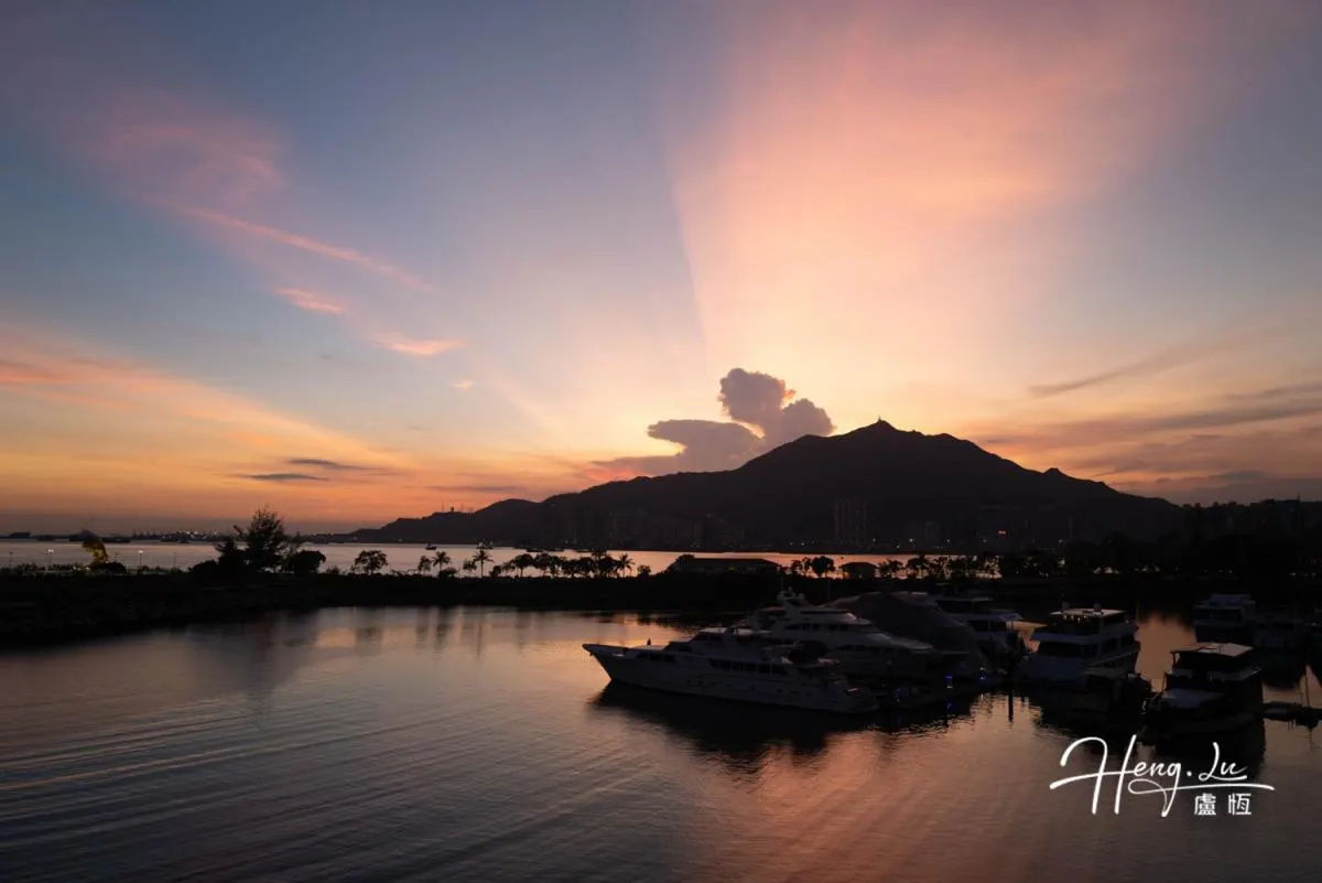 Sunset View Of Marina With Yachts And Mountains