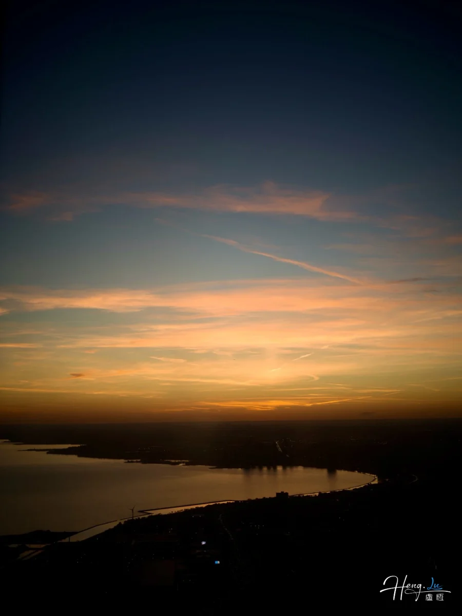 Sunset Over Coastline With Soft Orange Glow