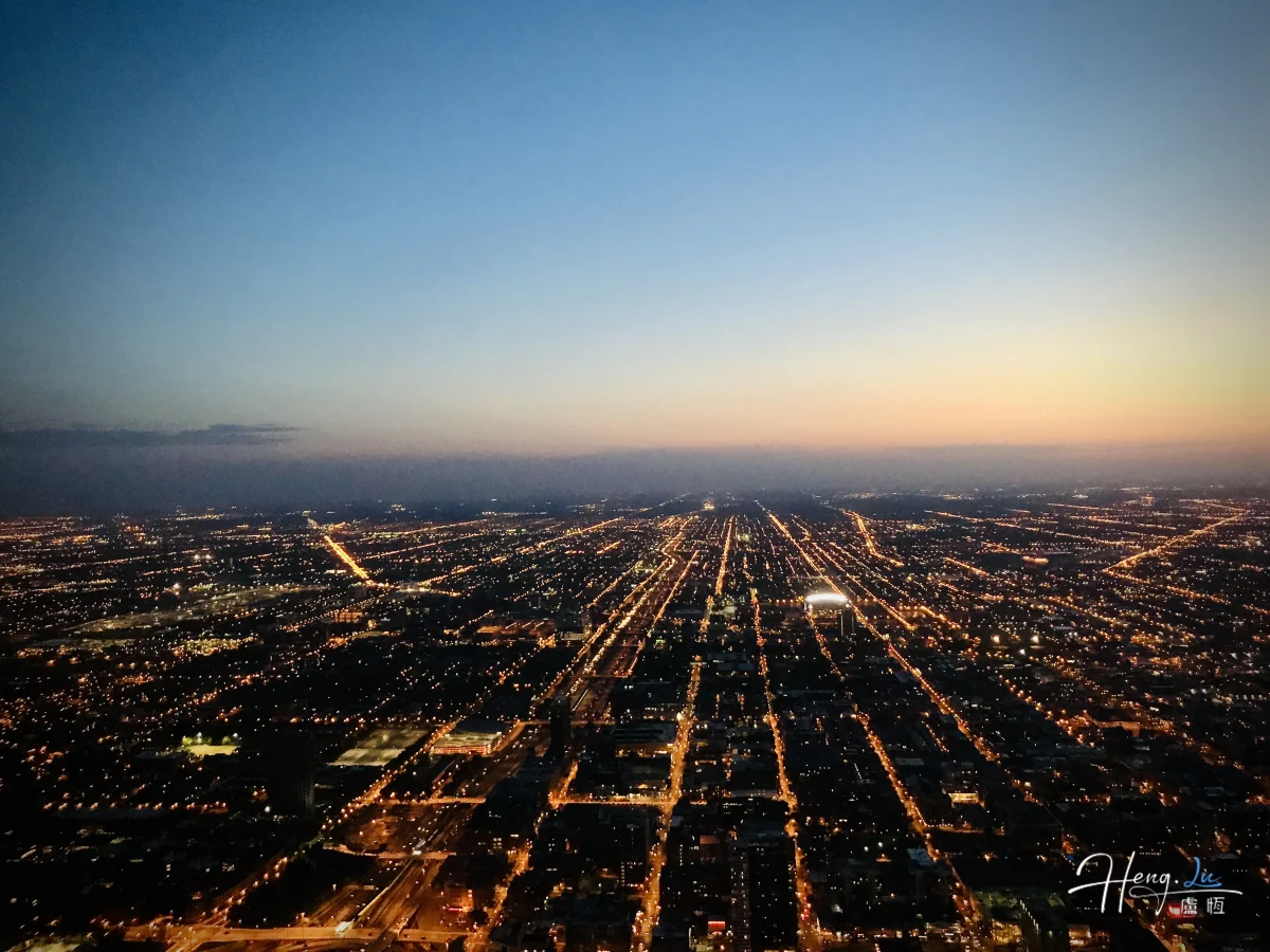 Cityscape At Dusk With Streetlights And Sunset Sky