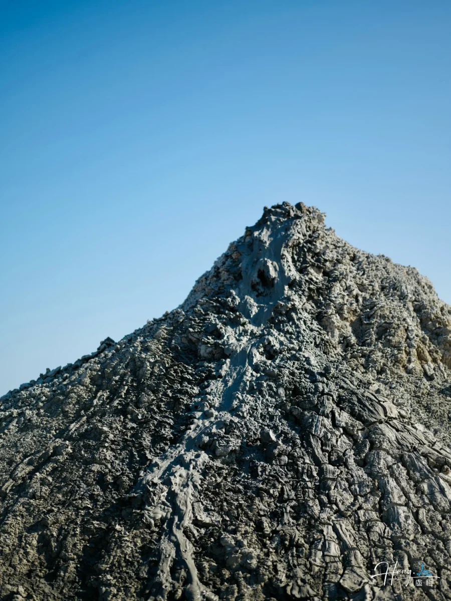Textured Mountain Peak Under Clear Sky