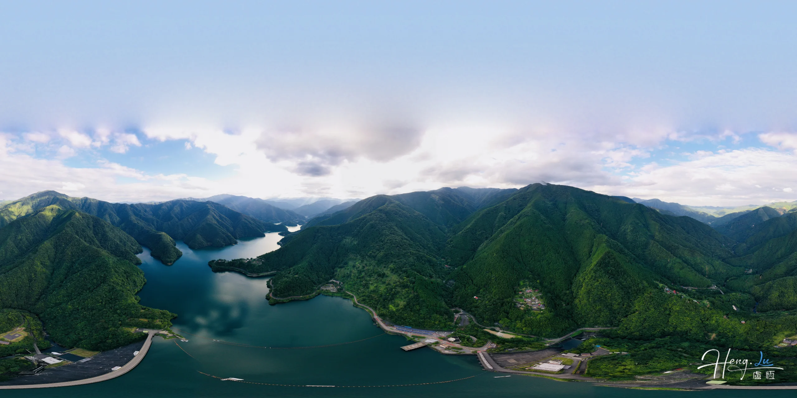 Aerial View of Winding Lake Among Lush Green Mountain Ranges
