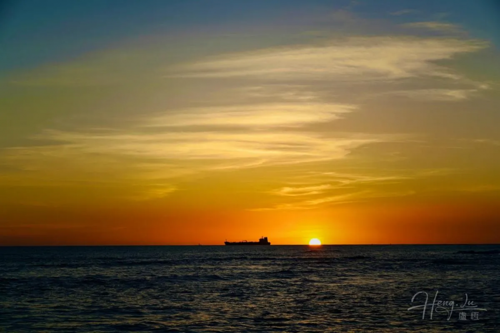 A Hawaiian Sunset with a Ship on the Horizon