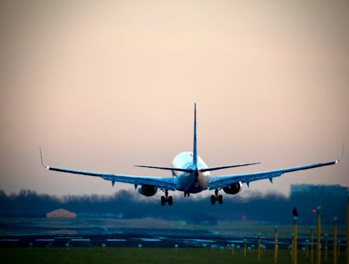 Airplane Taking Off At Dawn