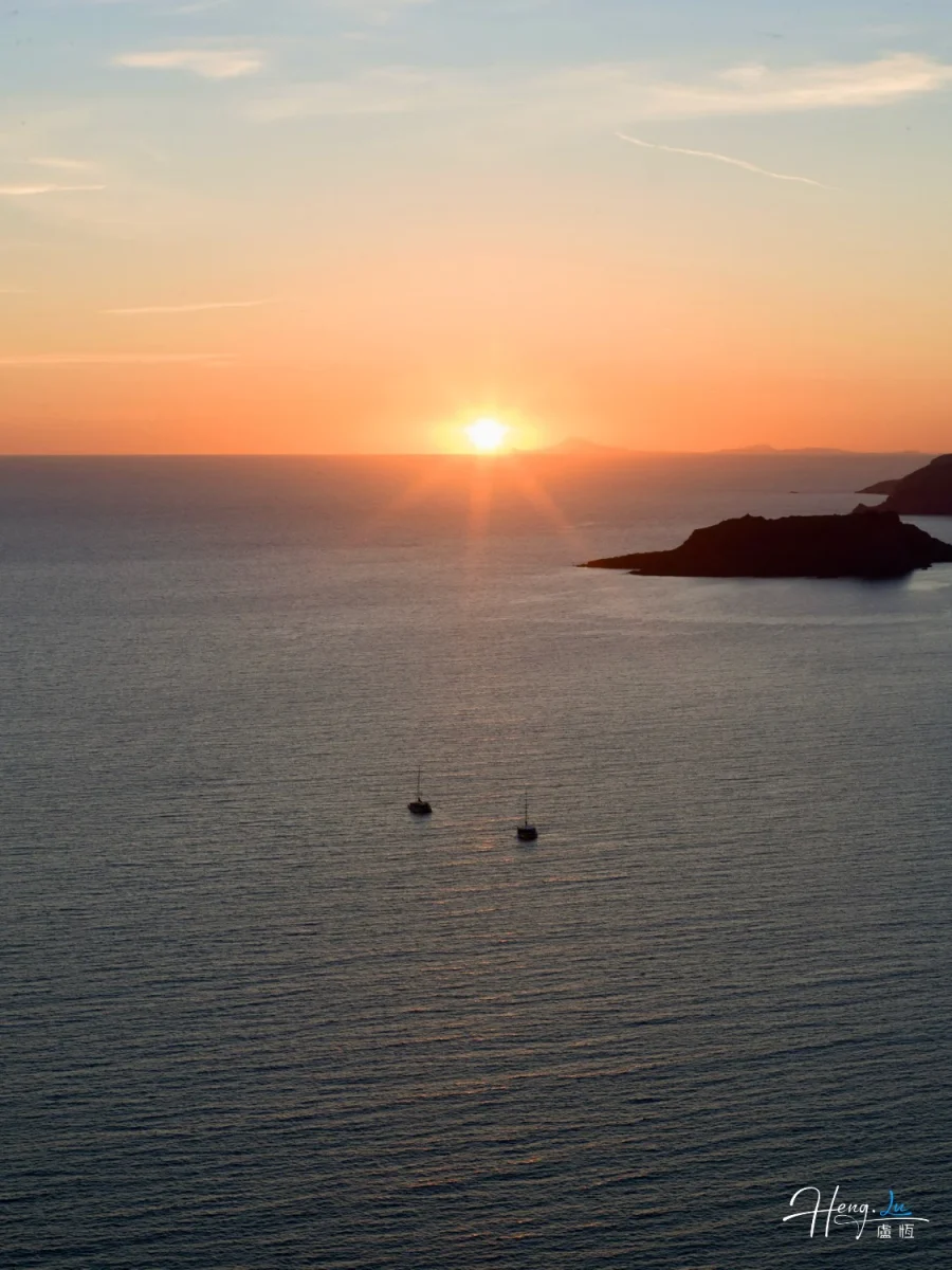 Sunset Over Sea With Two Sailboats