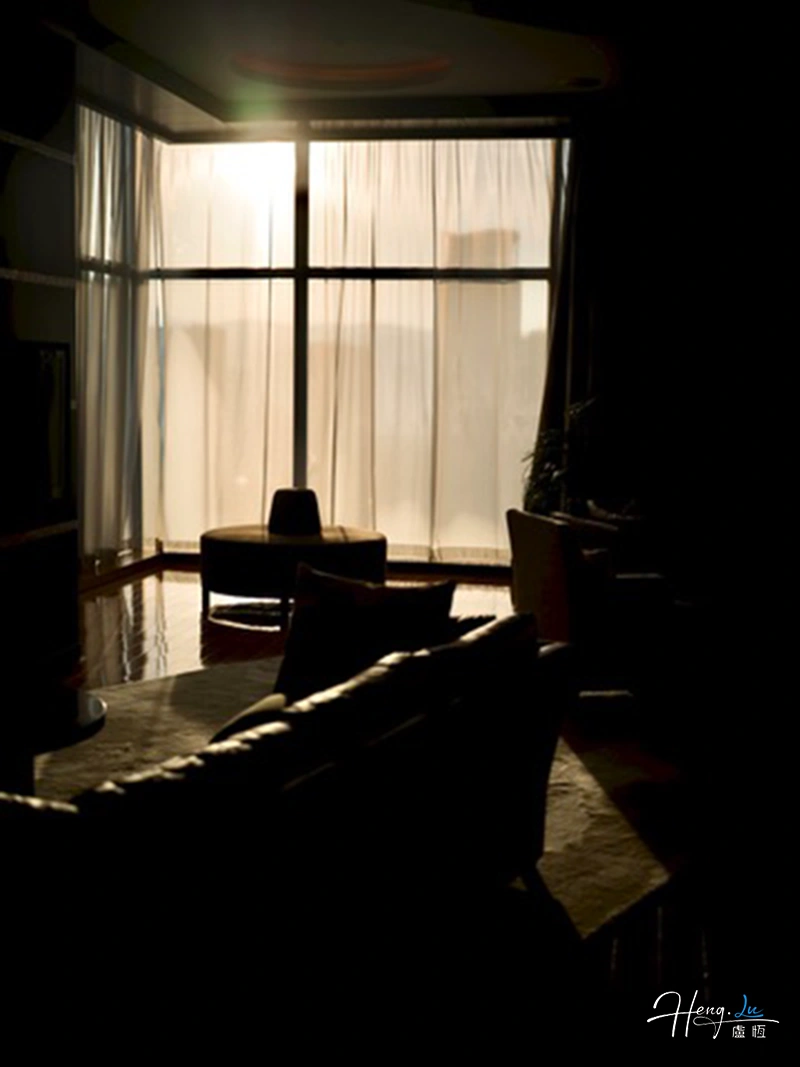 Sunlight Filtering Through Curtains In Dark Room