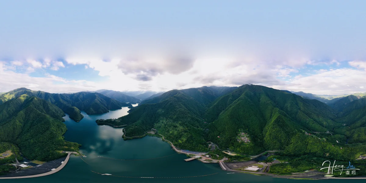 Aerial View Of Winding Lake Among Green Mountain Ranges