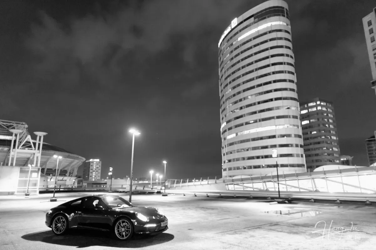 A Black Porsche In An Empty Parking Lot
