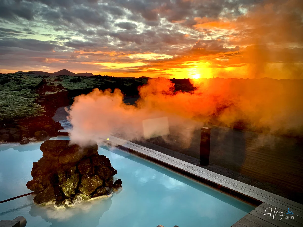 Steam Rising From Geothermal Pool At Sunset