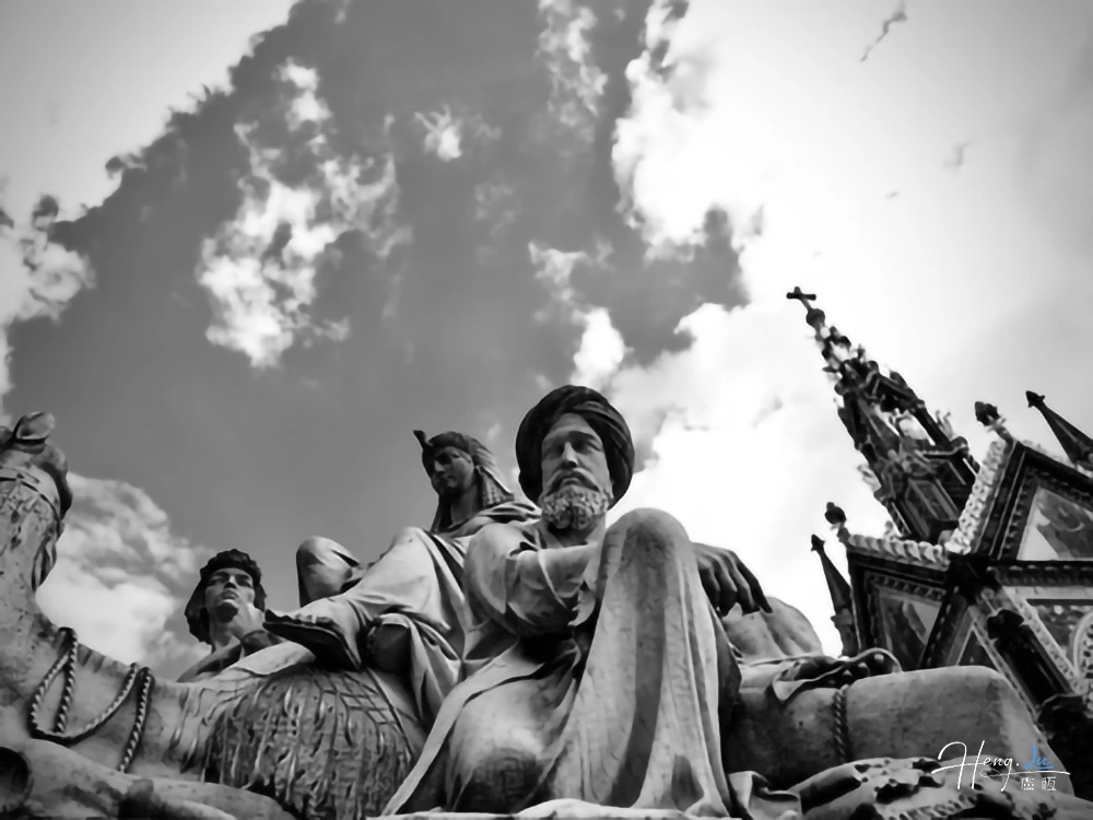 Black and white sculpture against dramatic sky