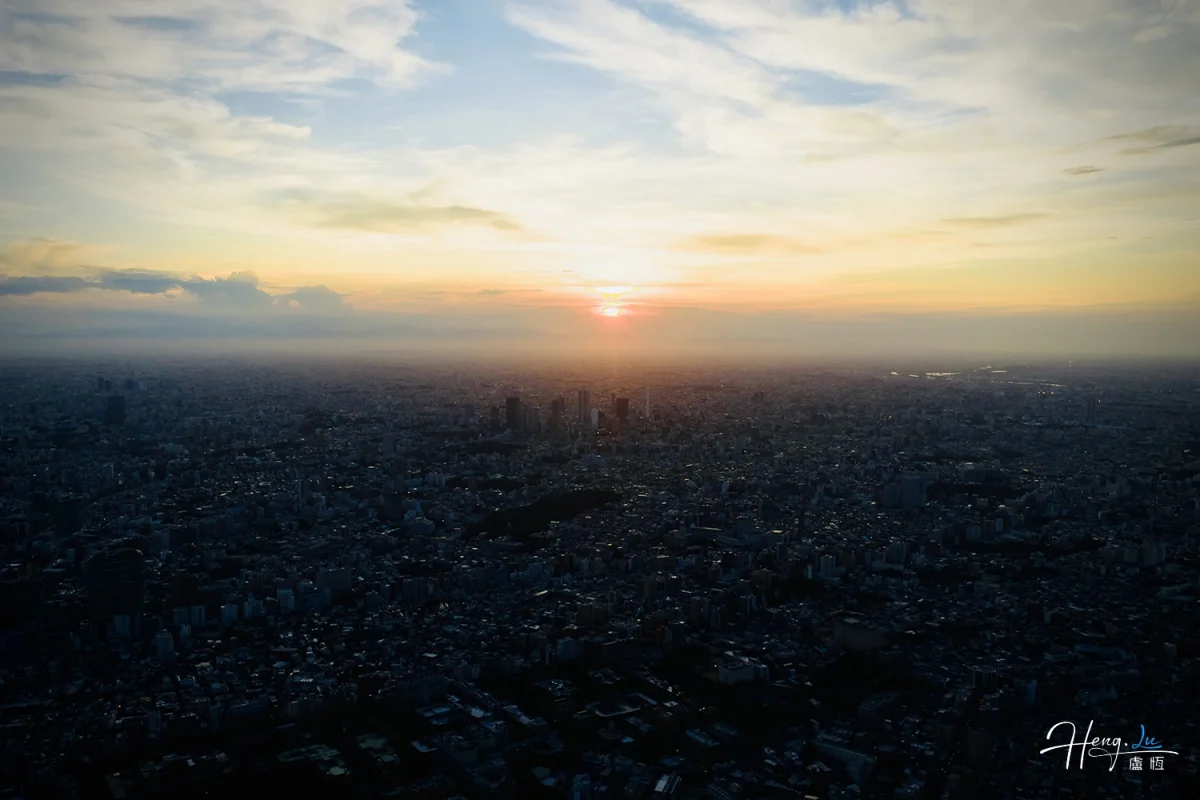 Sunset Over Dense Cityscape With Silhouetted Buildings