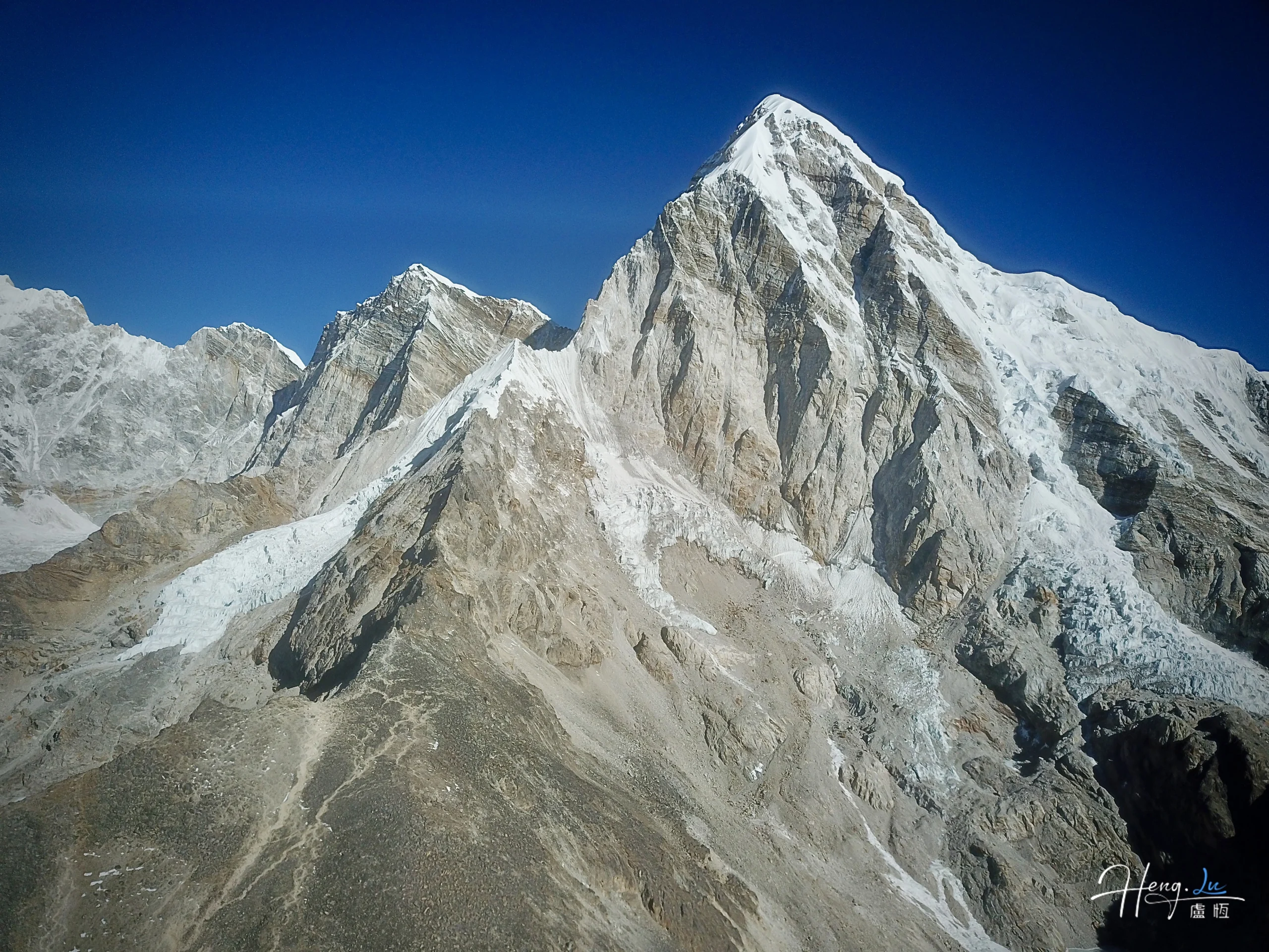 Snow covered mountain peaks under clear blue sky