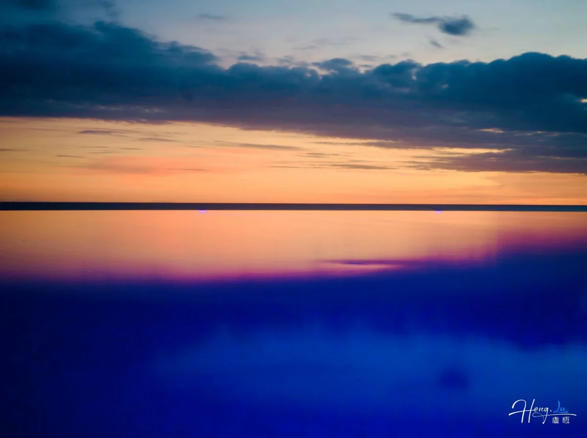 Tranquil Sunset Reflects Soft Colors Over Calm Water Horizon