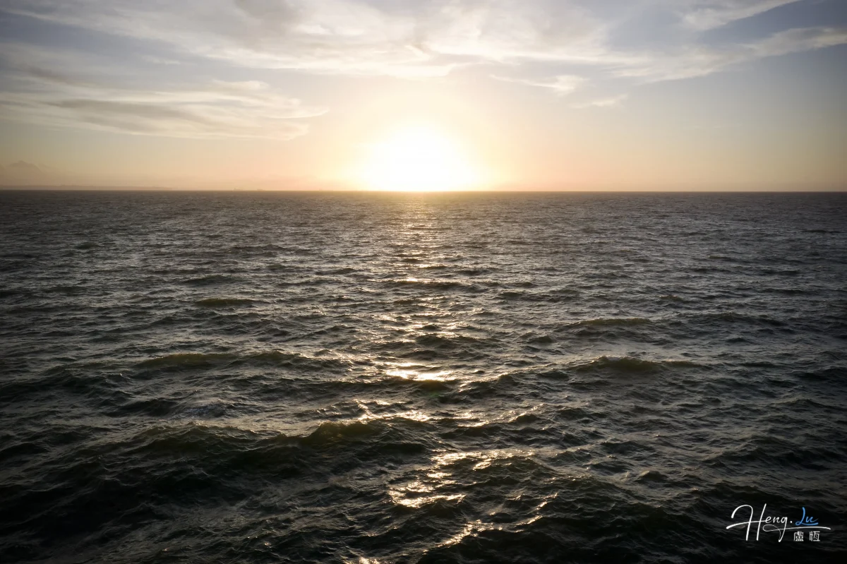 Sunset Over Ocean With Golden Light Reflecting On Waves