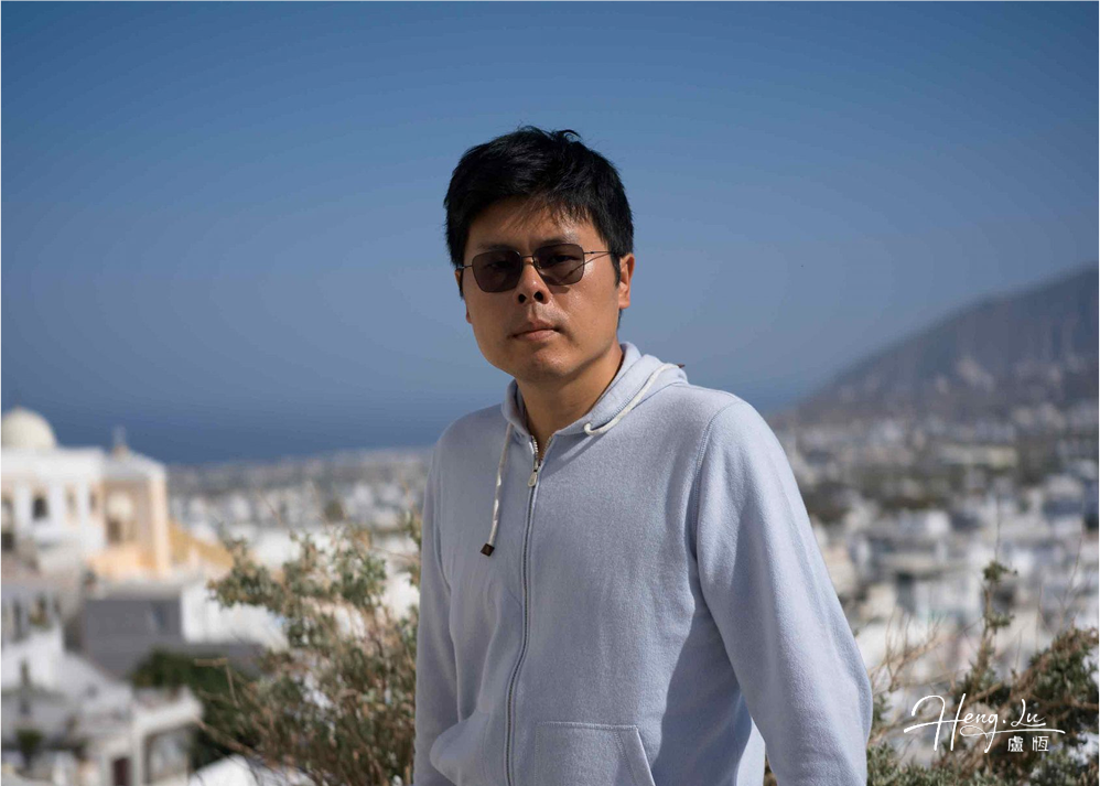 Man leaning on terrace with view of white town