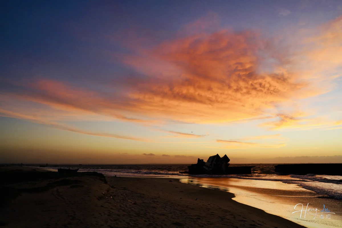 Golden Sunset With Colorful Clouds Over Seaside Wreck
