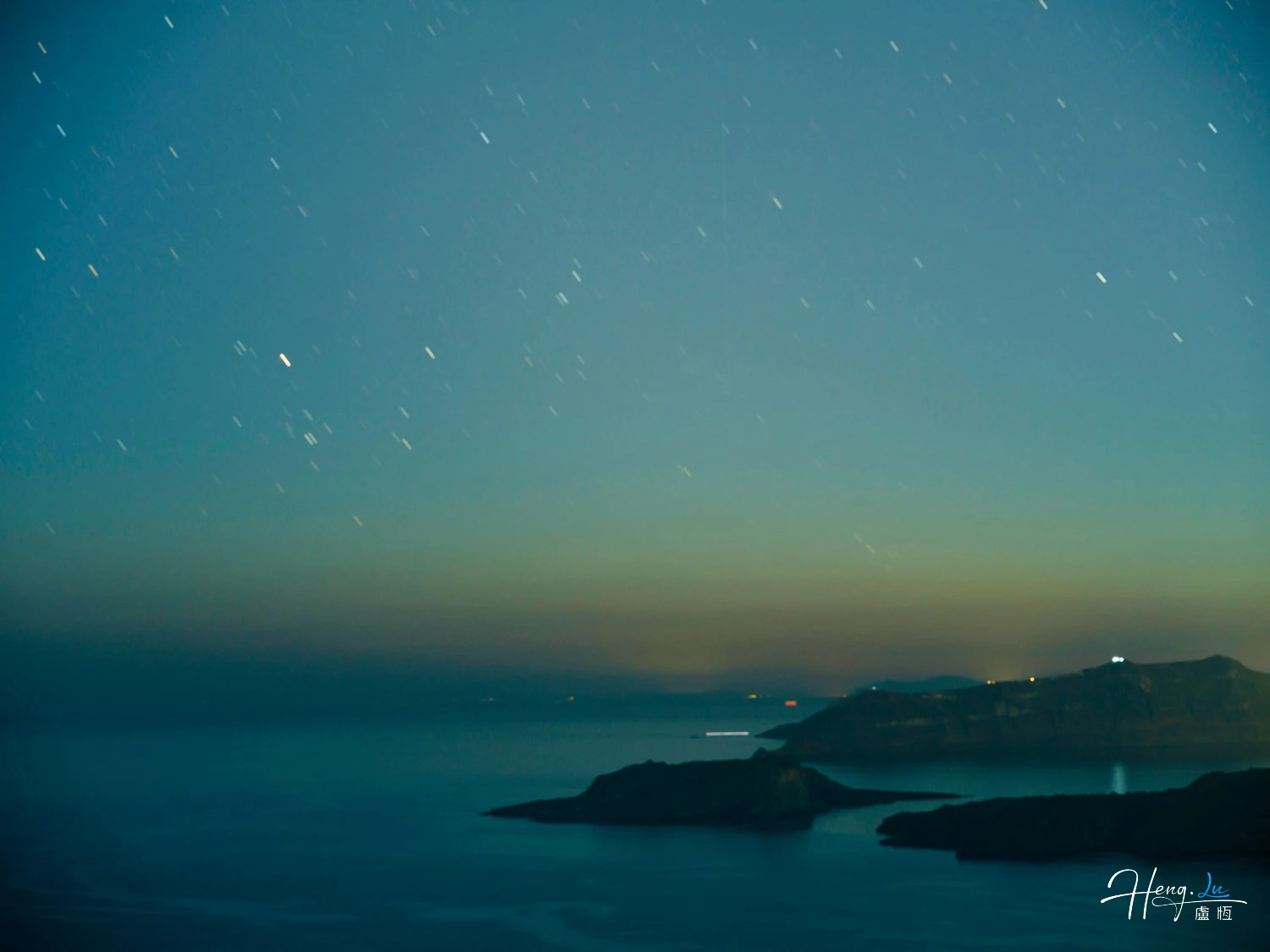 Night-sky-over-sea-and-distant-islands