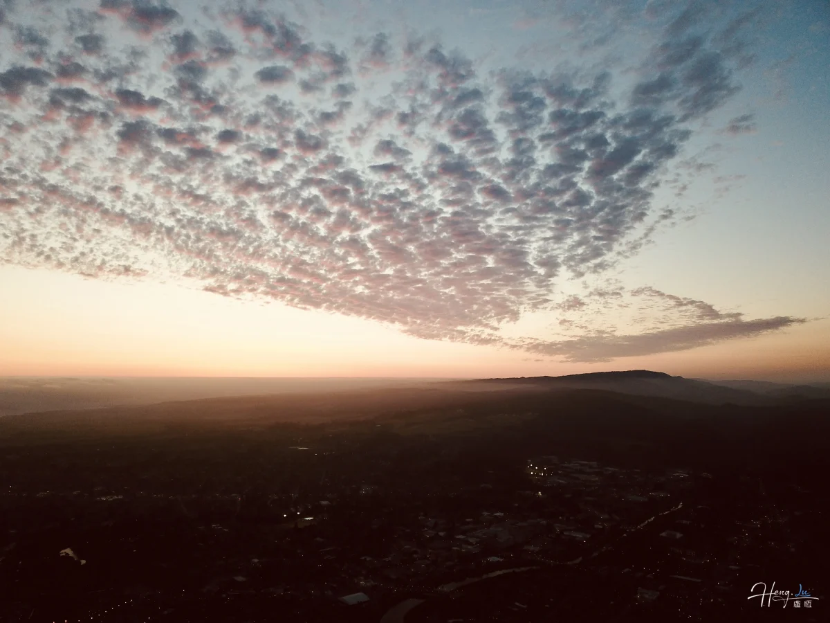 Dramatic Sunset Sky Over Hill And Cityscape