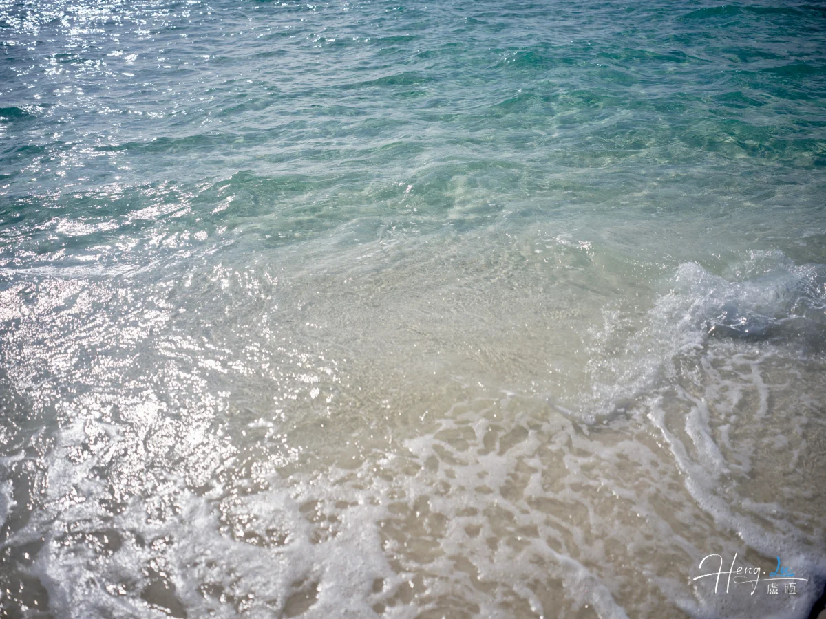 Clear Waves Rolling Onto Sandy Shore