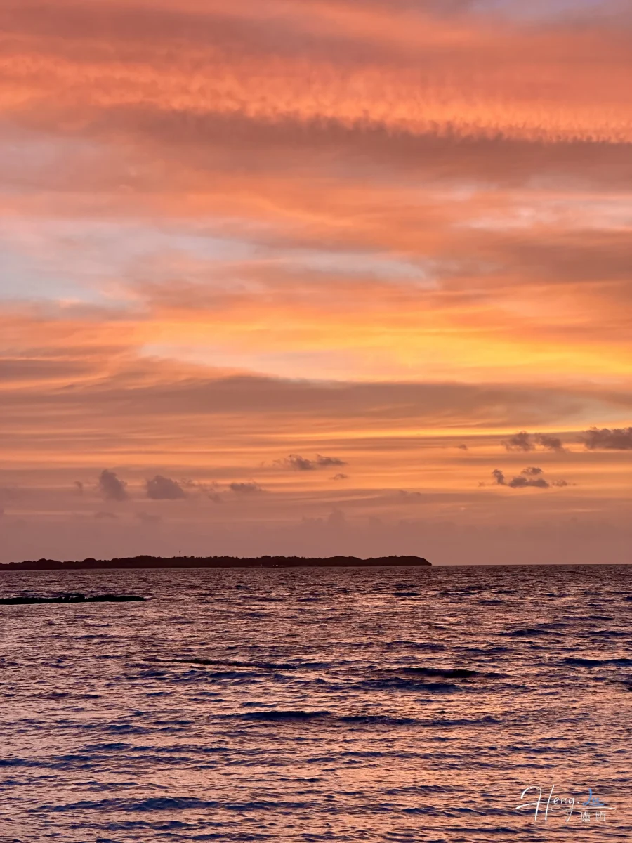 Sunset Over Ocean With Golden Clouds