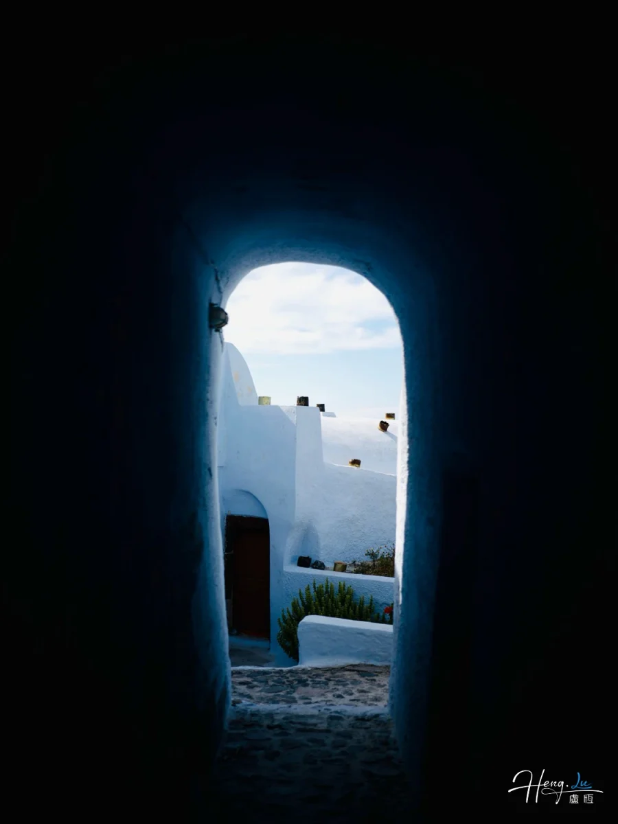 Blue Tunnel Leading To White Buildings