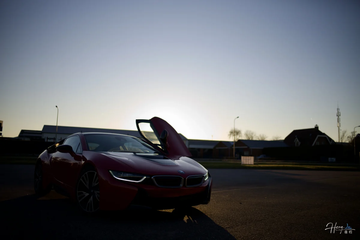 Red Sports Car Parked Under Sunset Sky