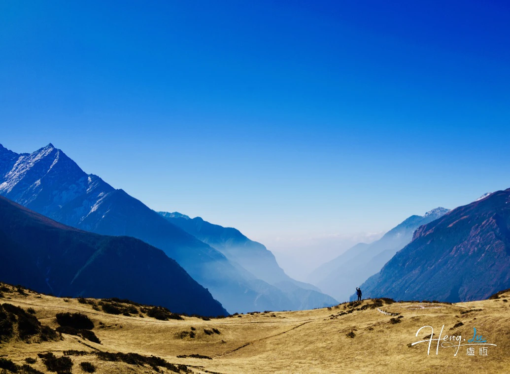 Misty Mountain Valley Under Deep Blue Sky