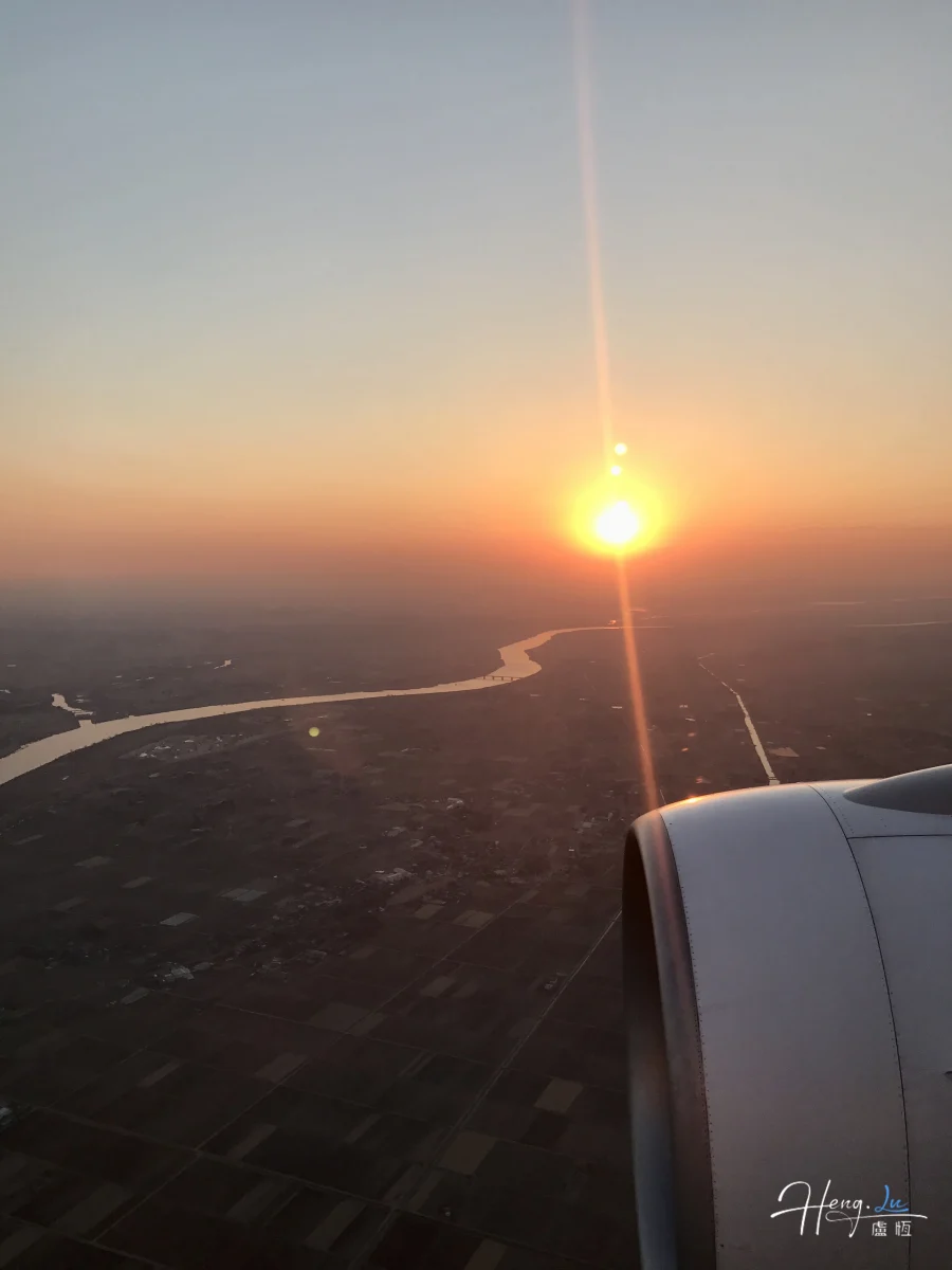 Airplane Wing Over River During Sunset Flight