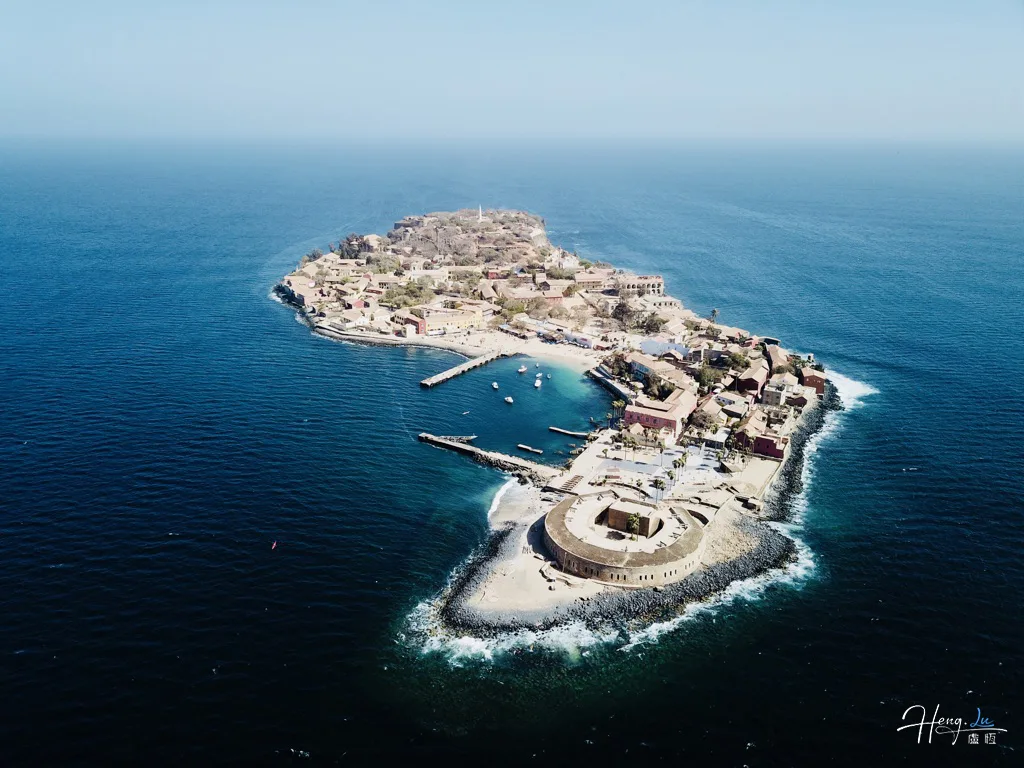 Aerial View Of Island Surrounded By Deep Blue Sea