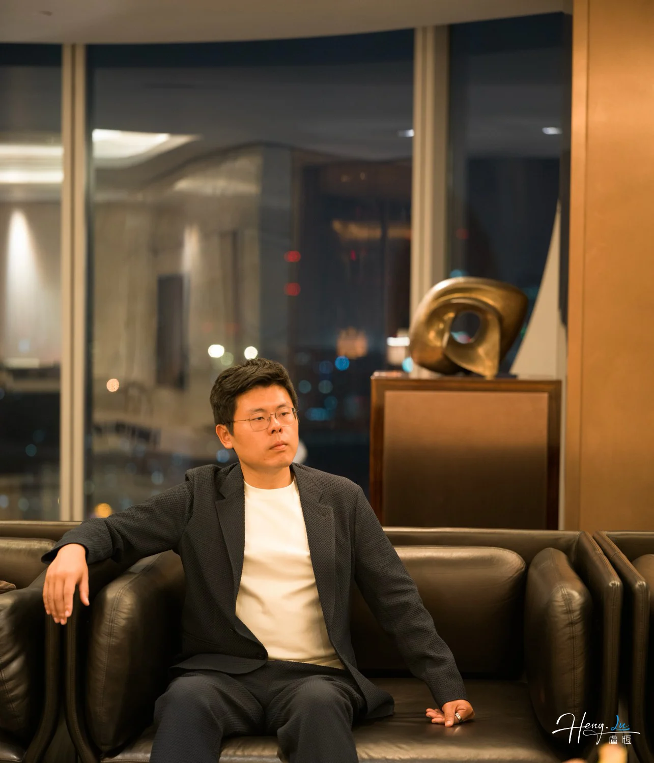 Luheng-sitting-on-sofa-in-modern-lounge