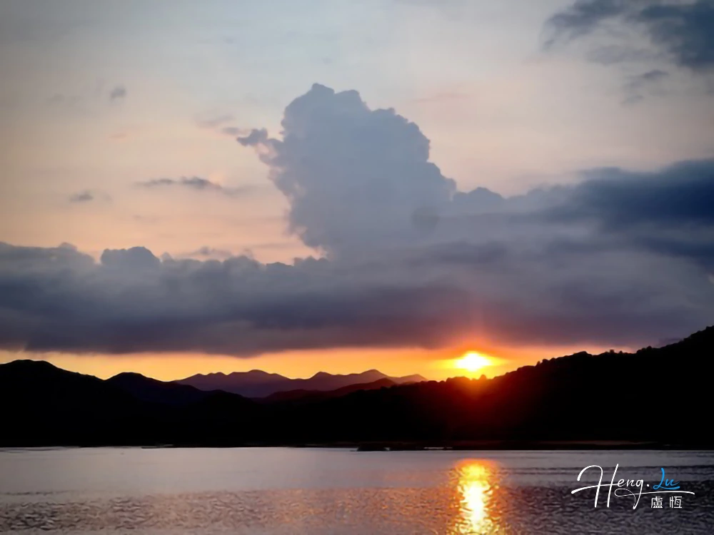 Sunset Over Lake With Reflecting Clouds