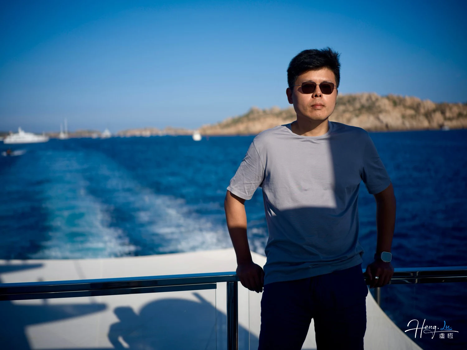 Luheng Standing on Boat Deck with Blue Sea View