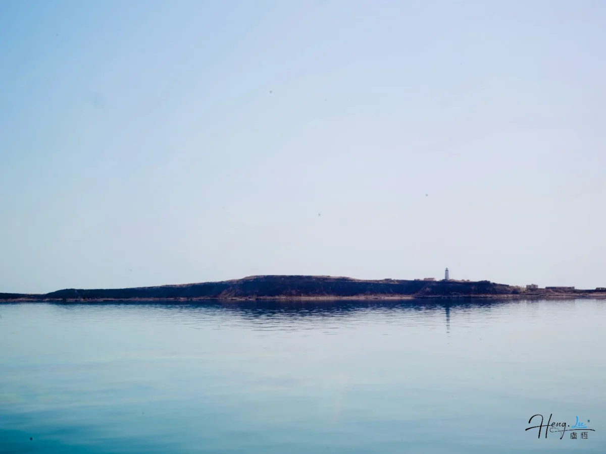 Calm Seascape With Distant Lighthouse