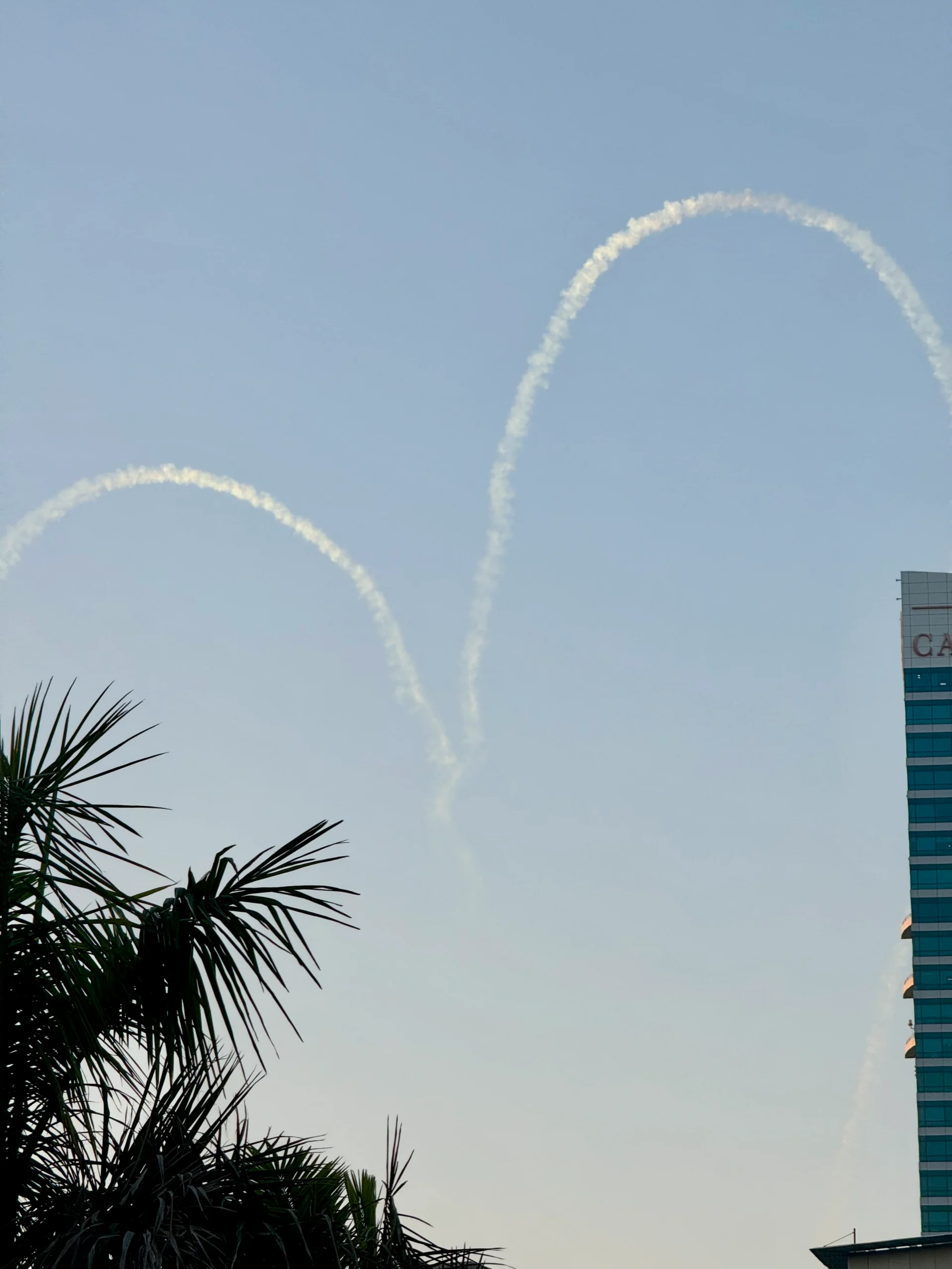 Smoke trails looping over skyline