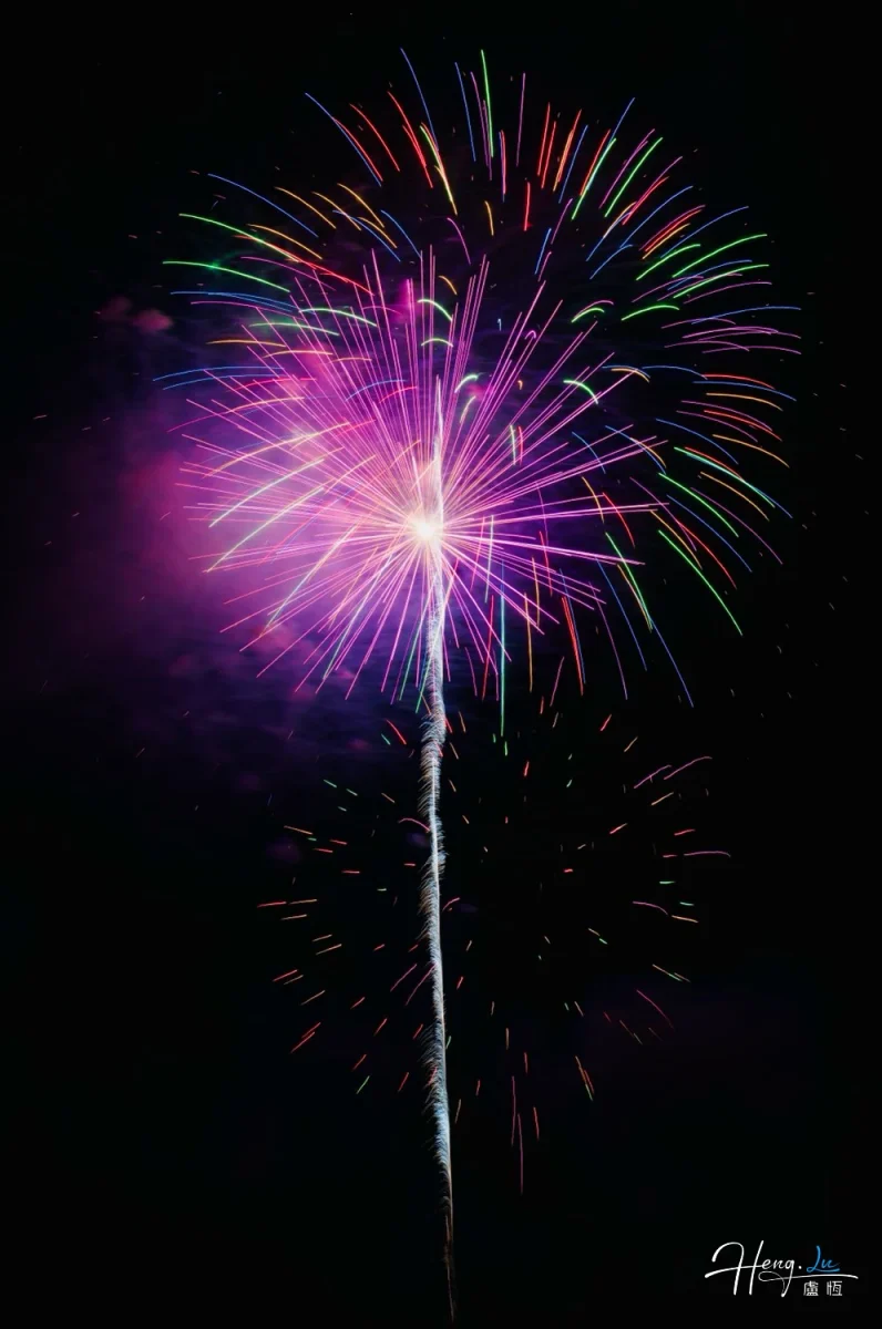 Colorful Firework Explodes With Radiant Purple Glow Against Night Sky