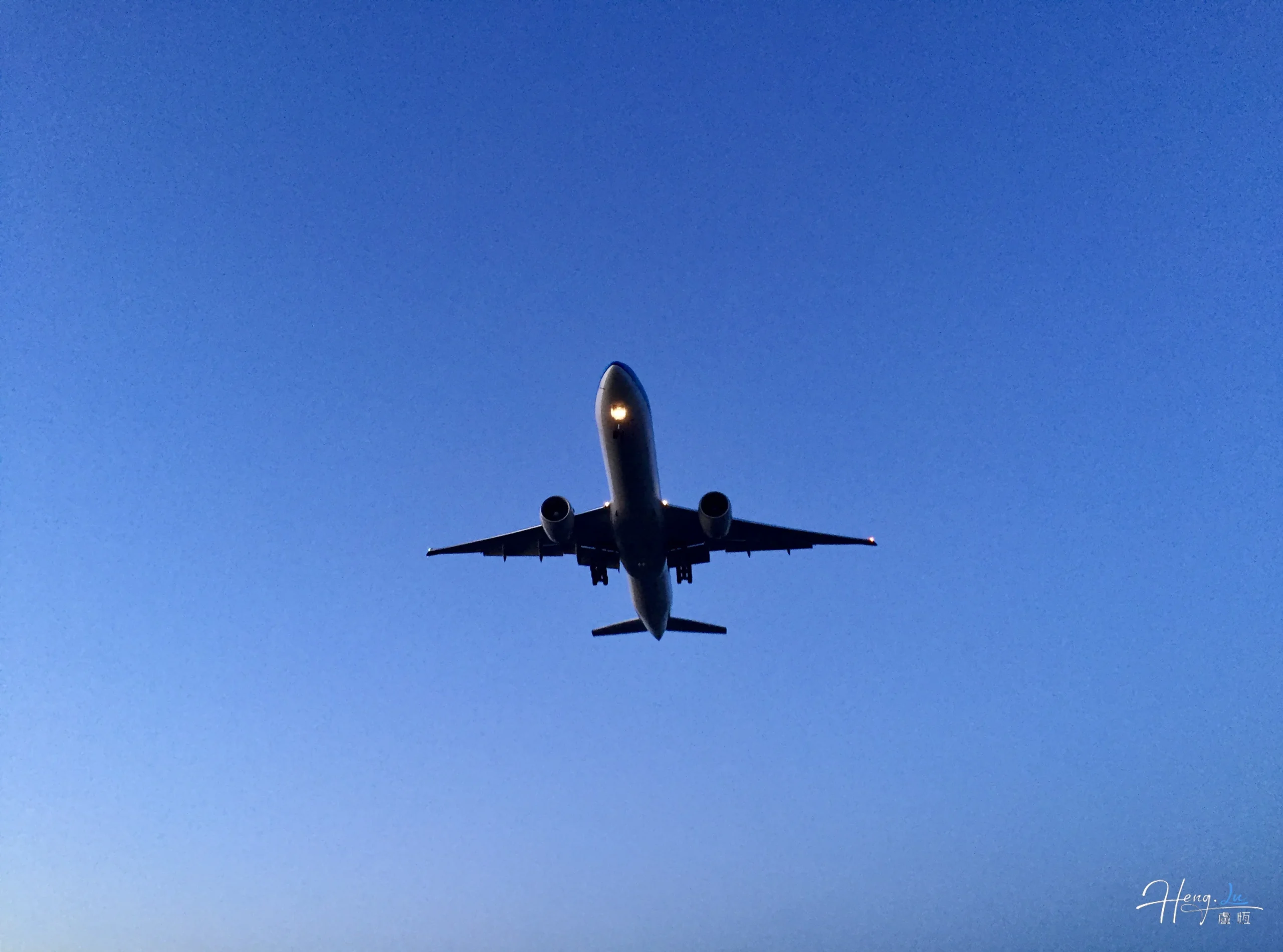 Airplane flying against clear evening sky