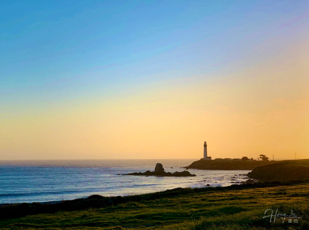 Lighthouse on Rocky Coast Sunset sky