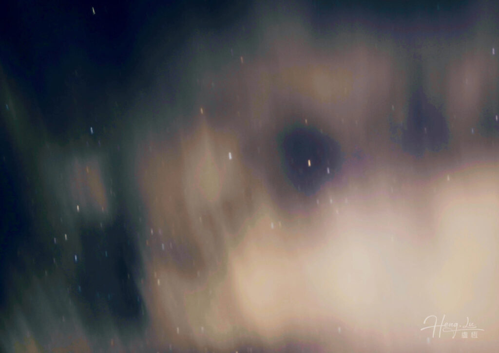 Starry night sky with moving warm clouds in dreamlike view