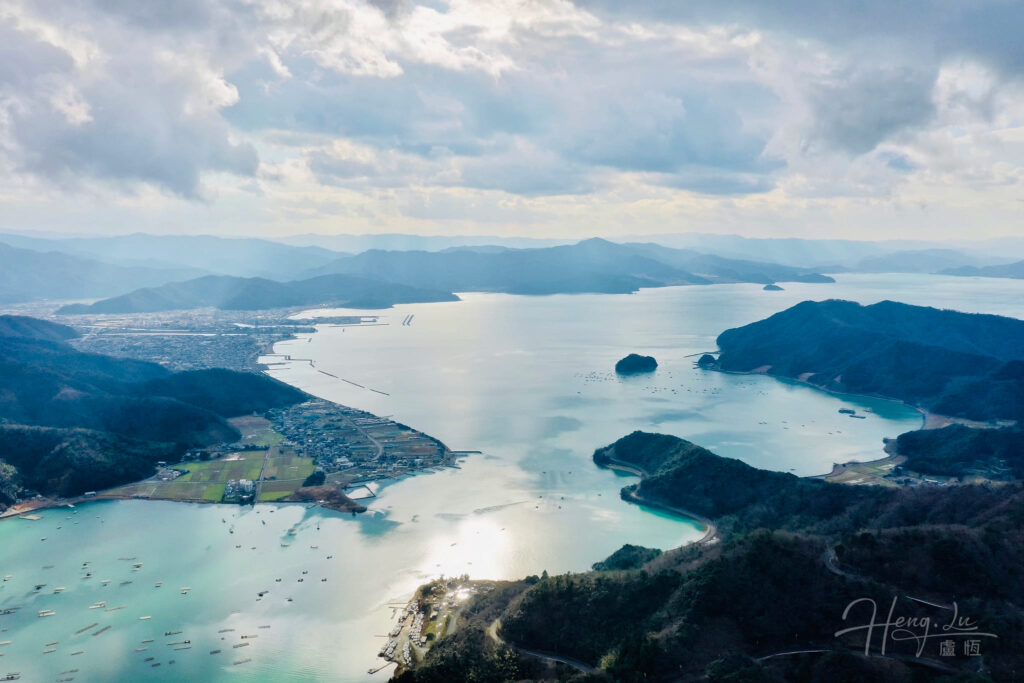 Aerial view of coastal bay with islands and mountain landscape