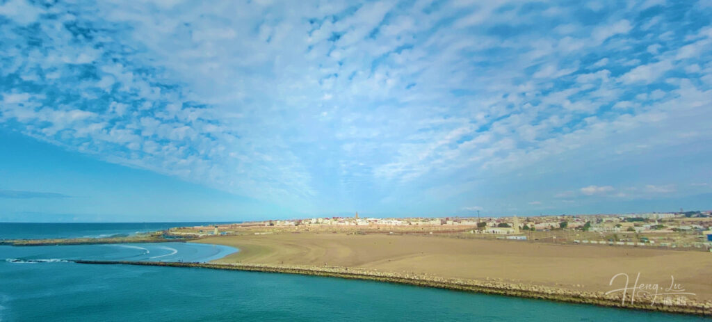 Blue sky and coastal city view with wide horizon
