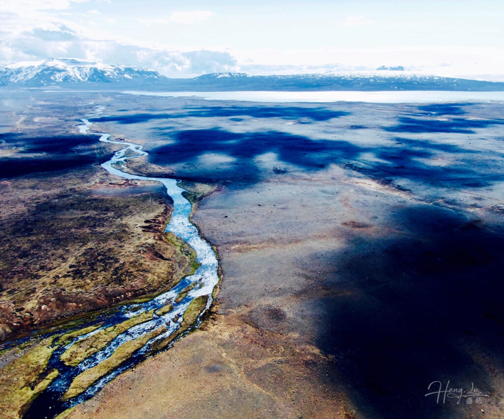 Aerial view of winding river across vast mountain landscape