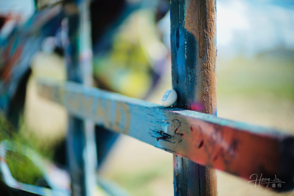 Painted fence detail with stone on Route 66