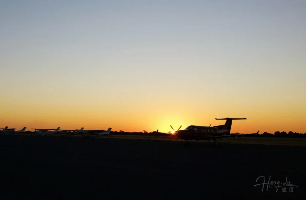 Airplanes Parked on Runway with African Sunset in Background Airplanes-parked-on-runway-with-Africa-sunset-in-background