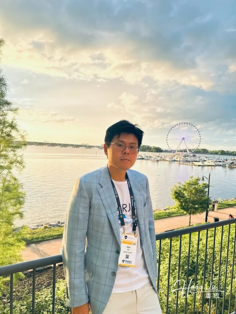 Lu Heng at sunset by the seafront beating up on IPv4 and internet governance Luheng-in-blazer-posing-by-waterfront-with-Ferris wheel