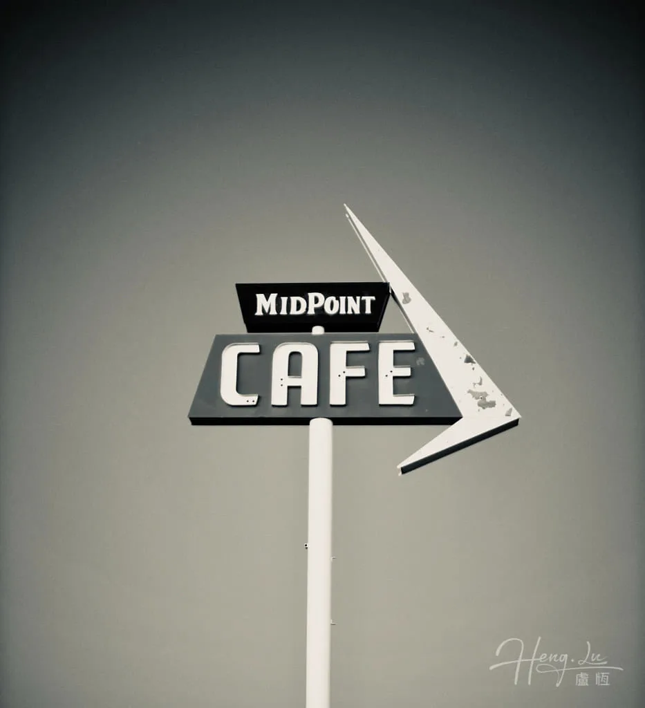 A vintage Midpoint Cafe sign against a sky A-vintage-Midpoint-Cafe-sign-against-a-sky