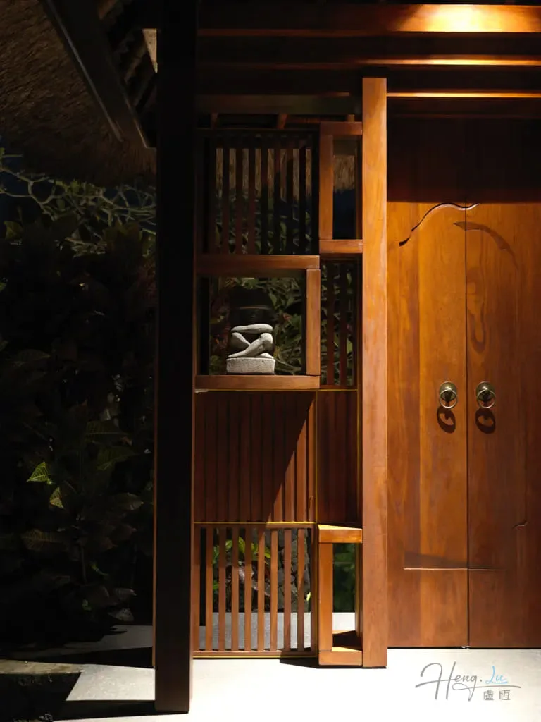 Tranquil wooden doorway with stones and screen A-wooden-door-and-screen-with-stacked-stones