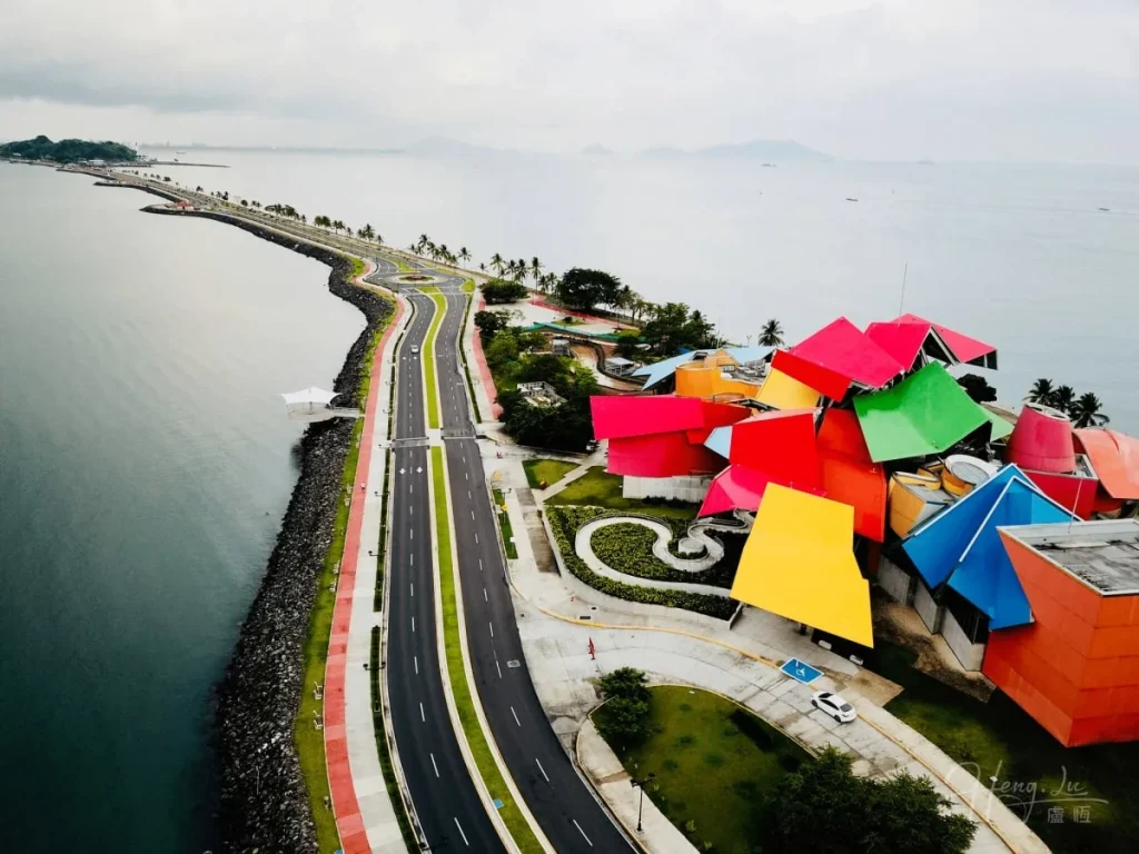 Vibrant Modern Building Along Coastal Roadbeside the Seaside Colorful-modern-building-by-coastal-road-and-seaside.