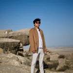 Luheng-standing-on-sunlit-rocky-plateau